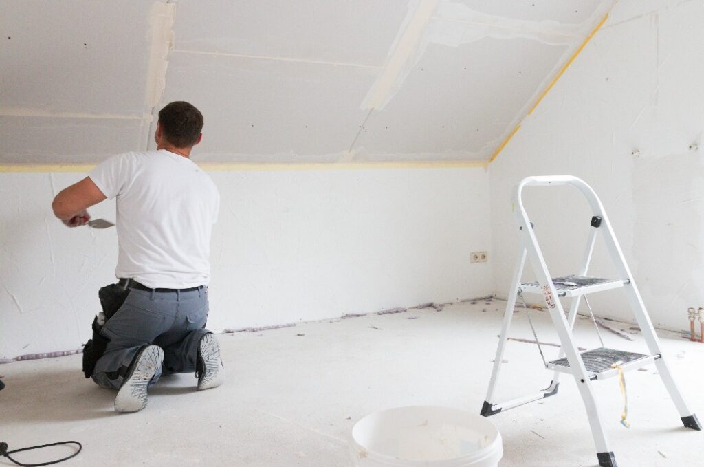 Handwerker spachtelt Gipskartonplatte - Trockenbau